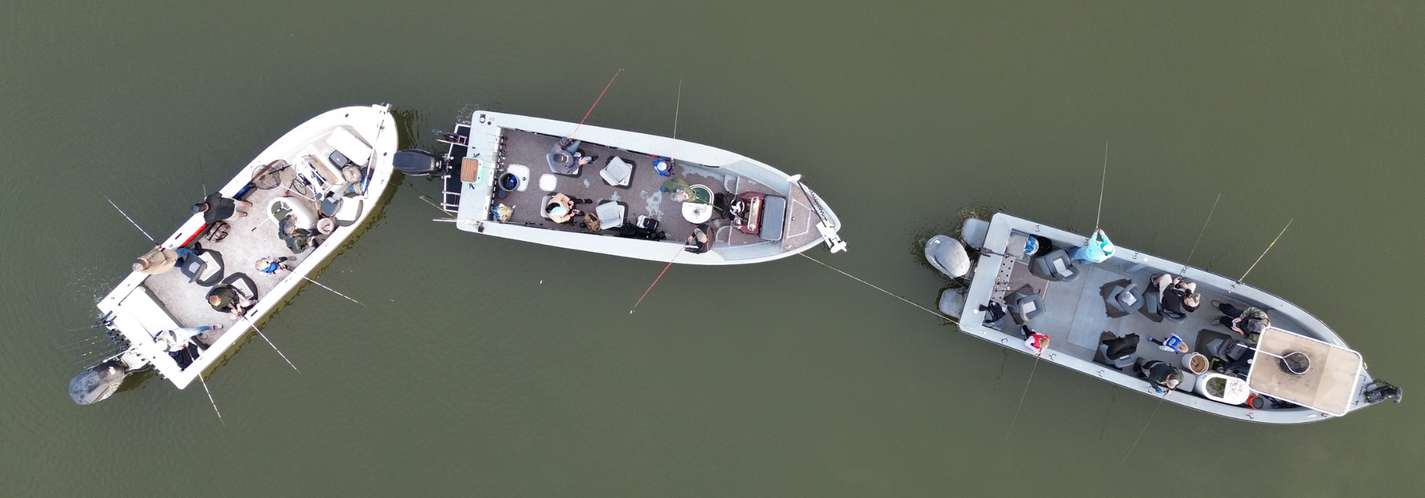 Aerial view of three fishing boats on calm water with anglers casting lines during a guided fishing trip on Lake Texoma Jacob Orr & Dan Barnett Lake Texoma Fishing Guides Angler Review